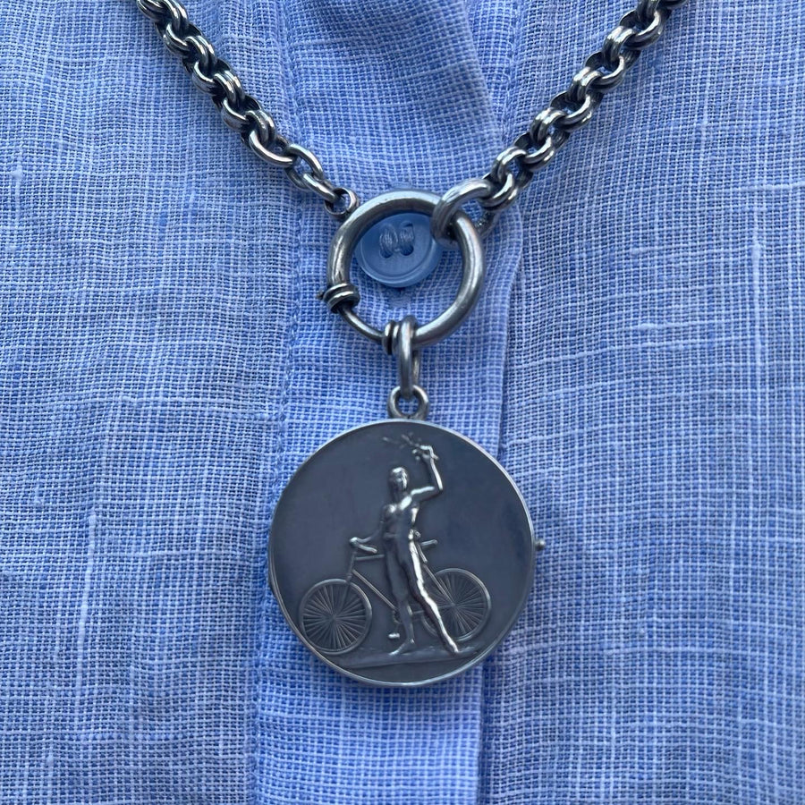 Antique Deco Silver Locket with a Victorious Cyclist